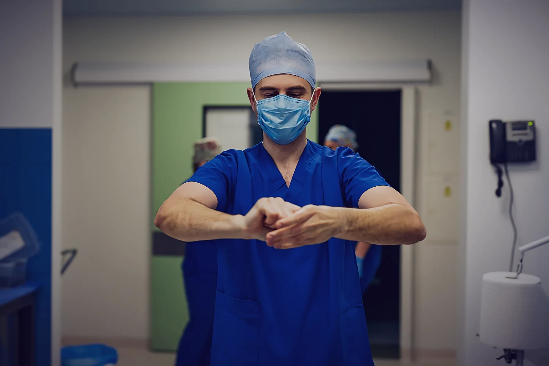 A surgeon scrubbing in before a case