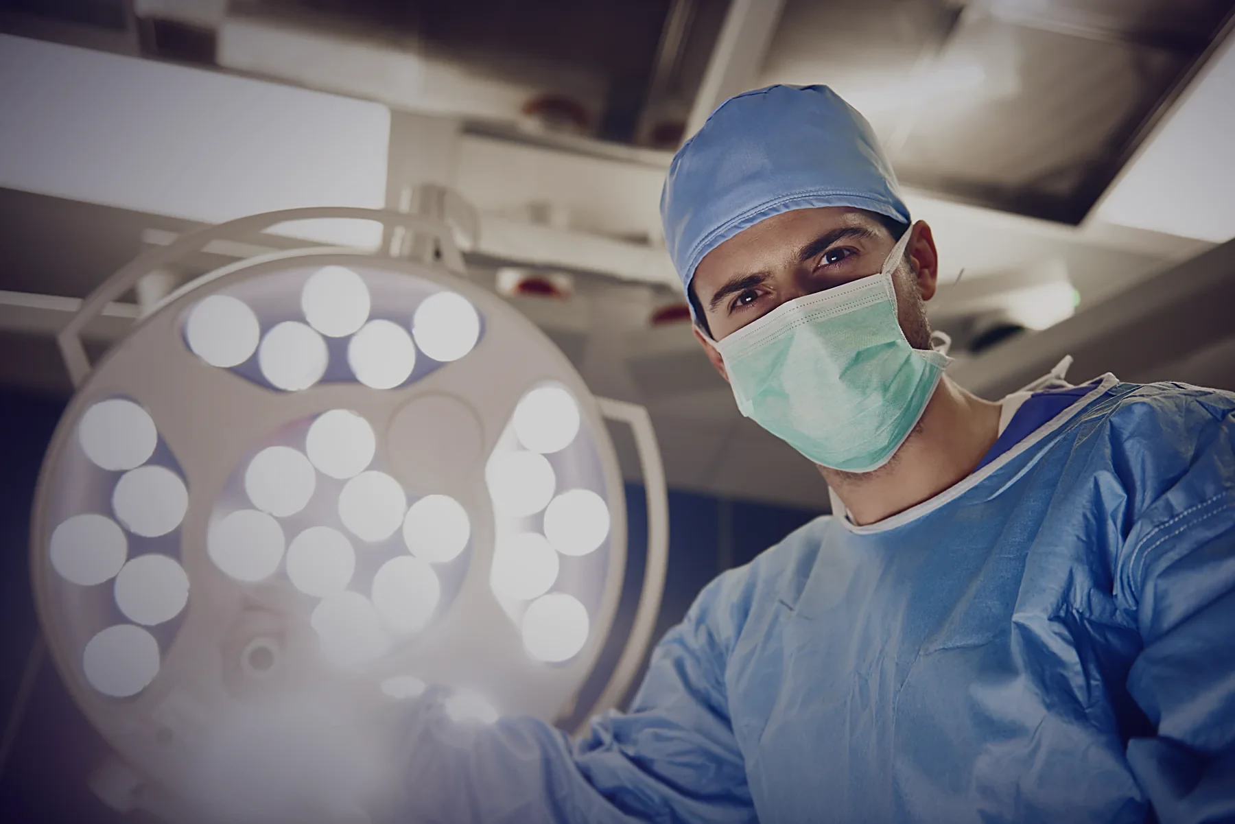 A surgeon positioning the theatre light before a case